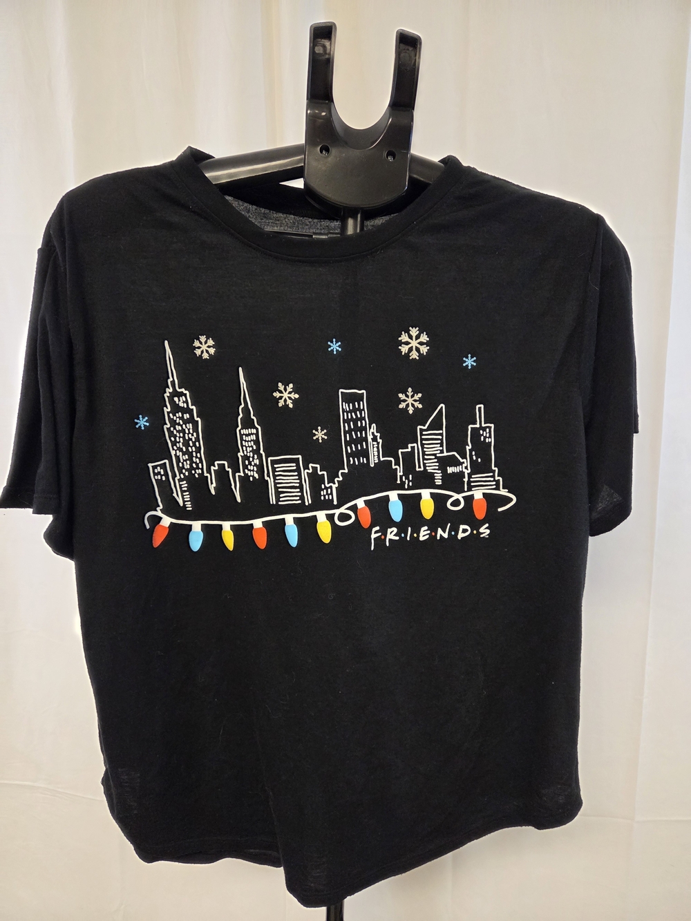 FRIENDS Black Tee with Colorful Holiday Lights and City Skyline